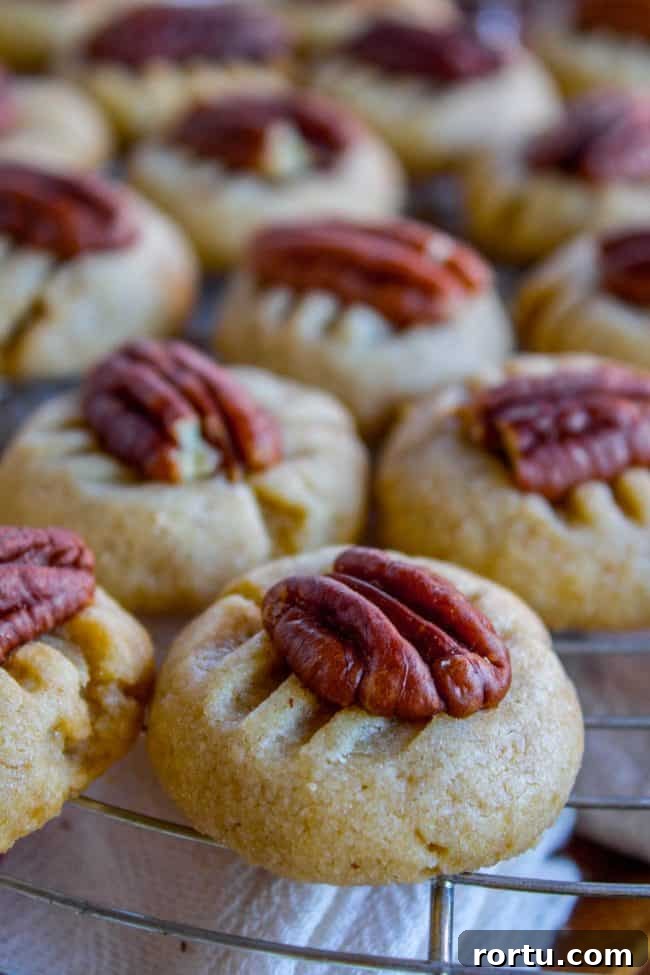 butter cookies with pecans on a cooling rack.