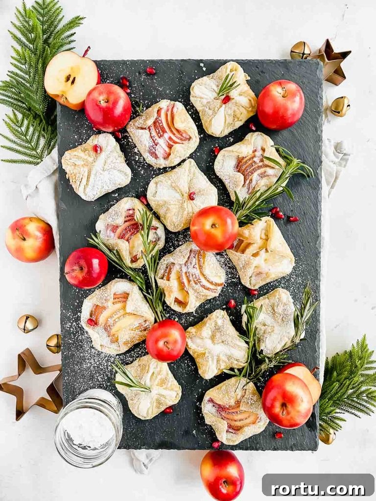 Apple Cinnamon Bites Recipe: Quick No-Bake Snack for Kids and Adults 11 apple cream cheese danishes dusted with powdered sugar arranged on gray serving platter.