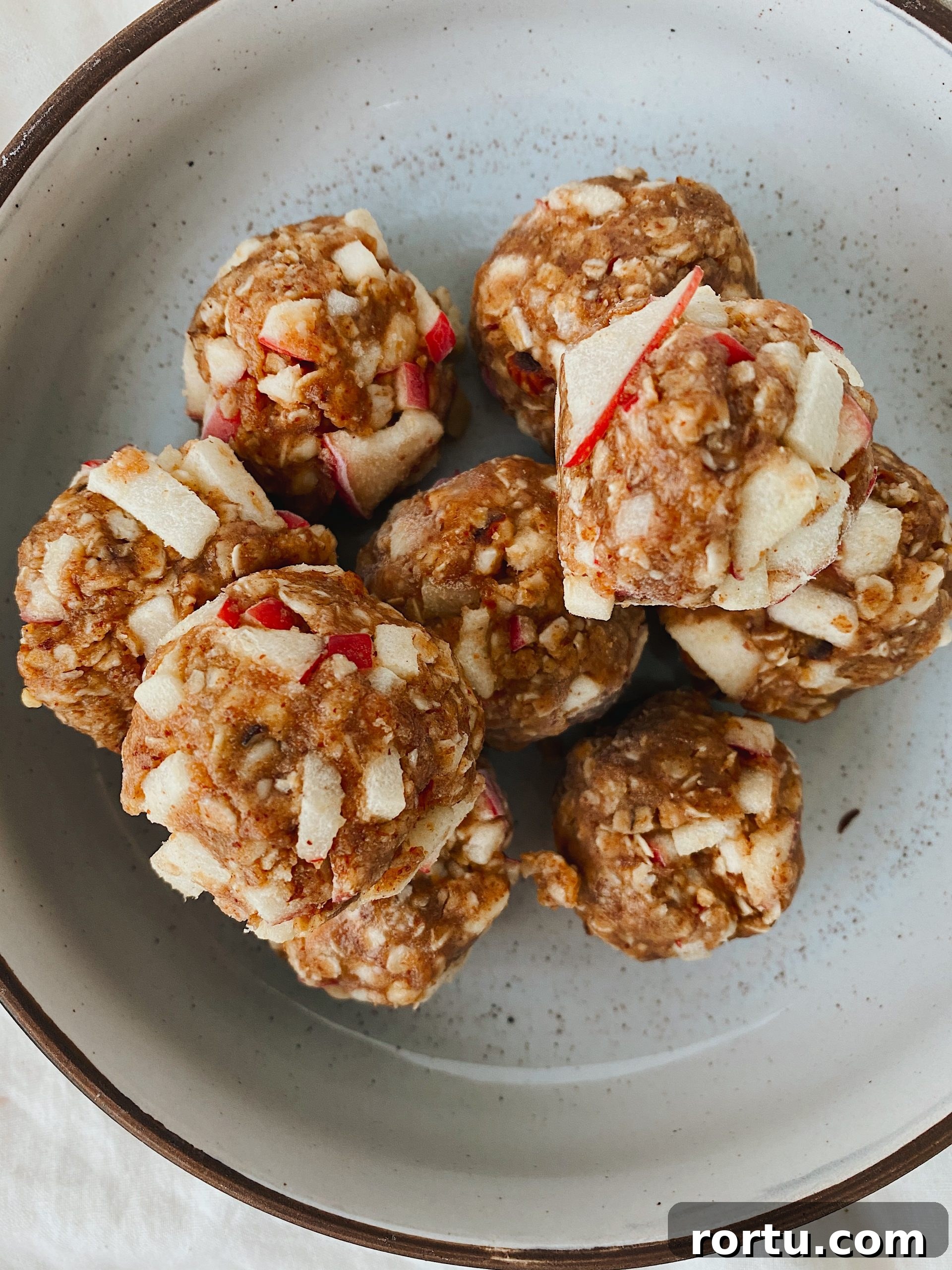 Apple Cinnamon Bites Recipe: Quick No-Bake Snack for Kids and Adults 13 apple cinnamon bites stacked tin white ceramic bowl.
