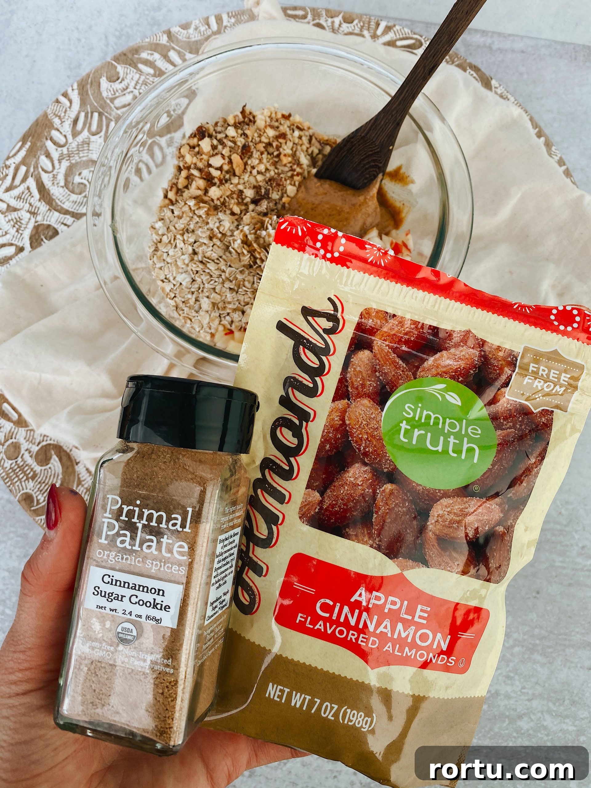 Apple Cinnamon Bites Recipe: Quick No-Bake Snack for Kids and Adults 3 hand holding cinnamon sugar and package of recommend nuts.