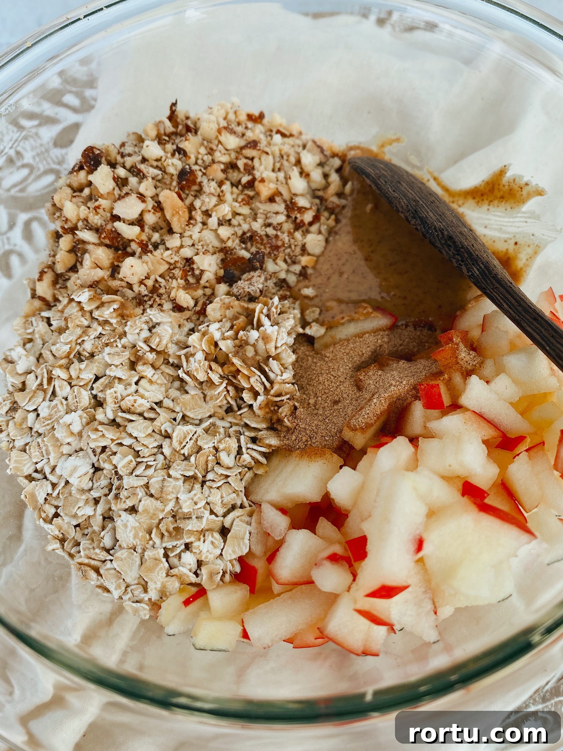 Apple Cinnamon Bites Recipe: Quick No-Bake Snack for Kids and Adults 5 All the recipe's ingredients for apple cinnamon bites in glass mixing bowl.