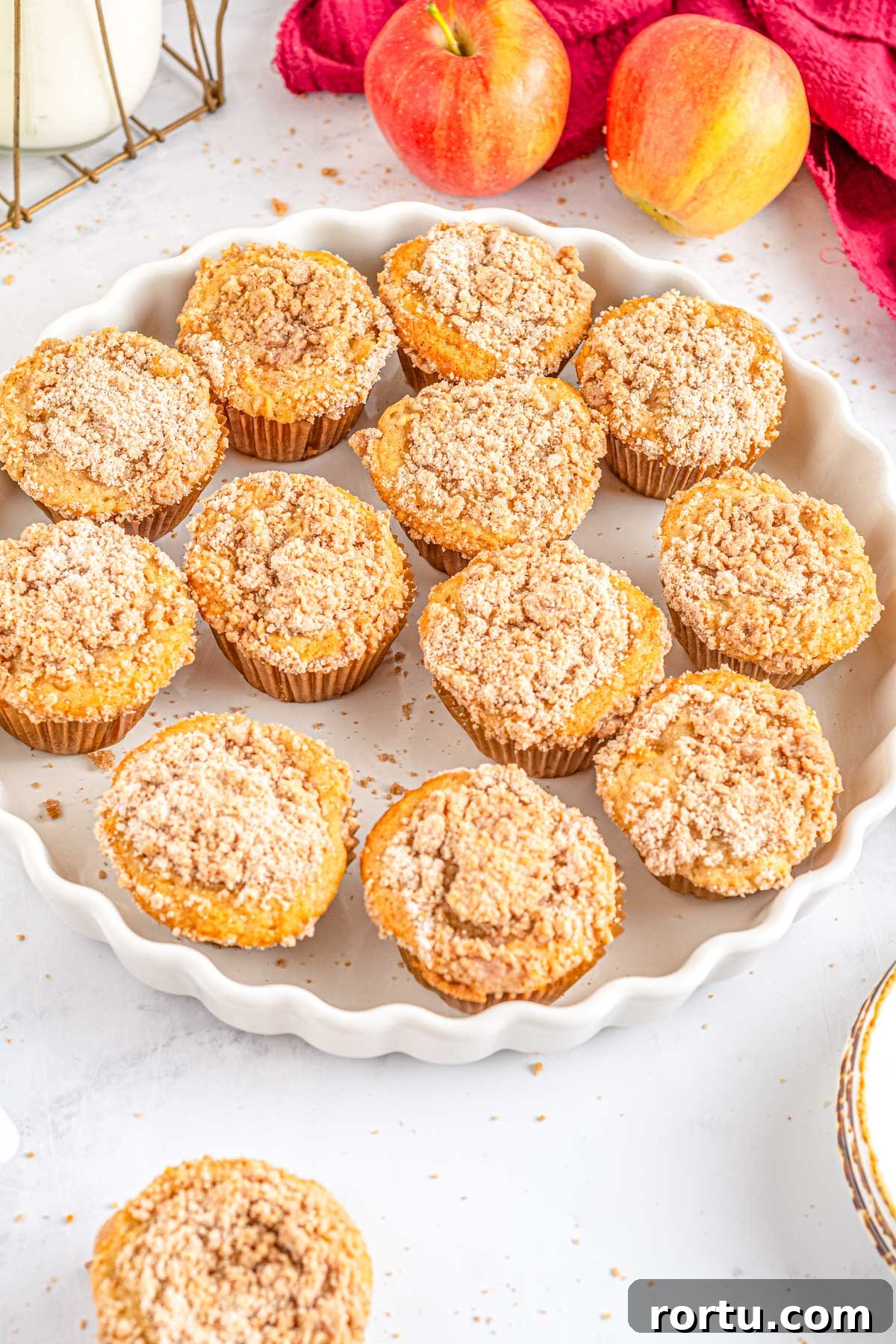 Apple cinnamon muffins on a white platter.