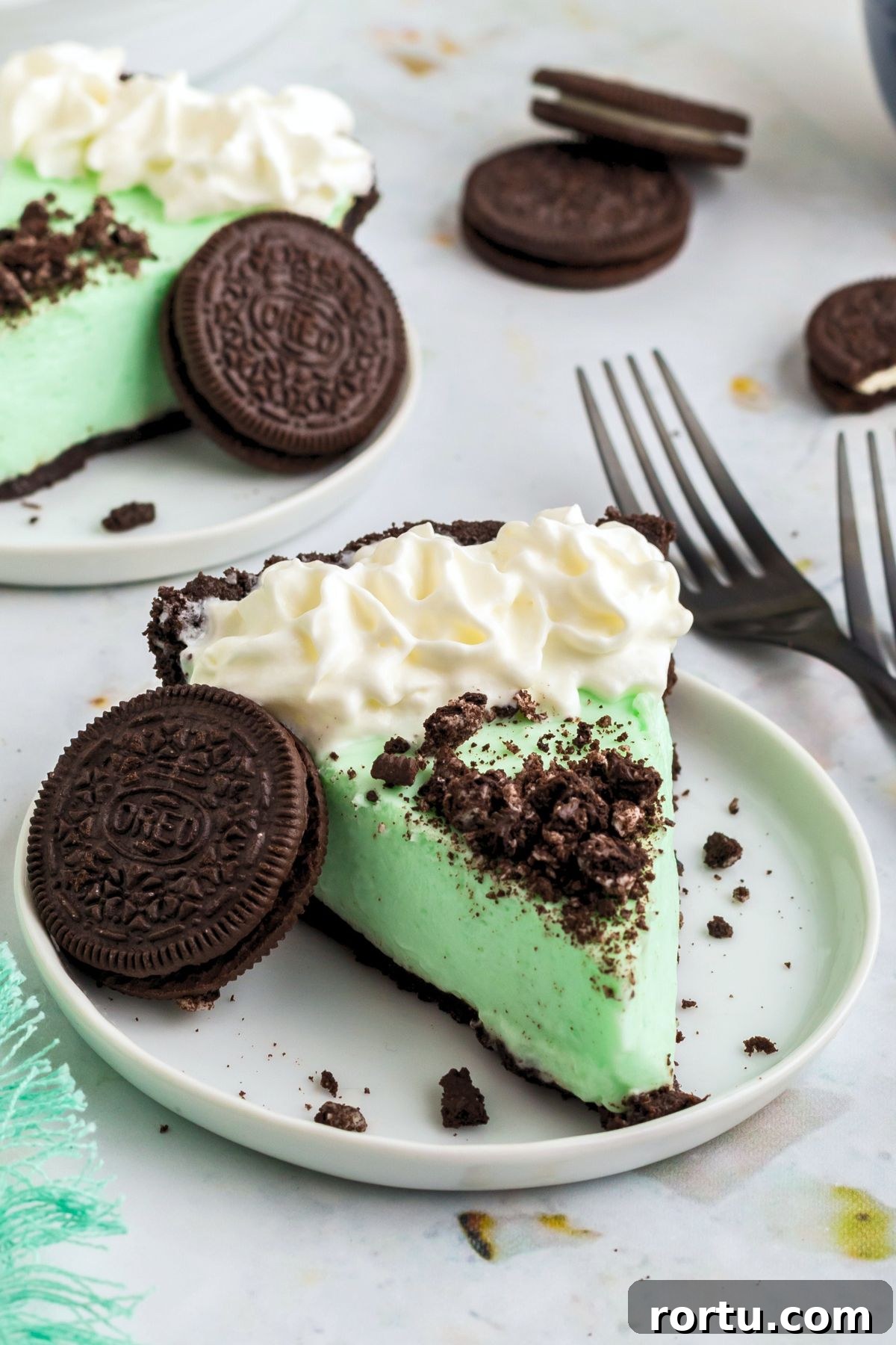 Creamy Mint Grasshopper Pie Recipe That Impresses 2 Slice of grasshopper pie on a small white plate.