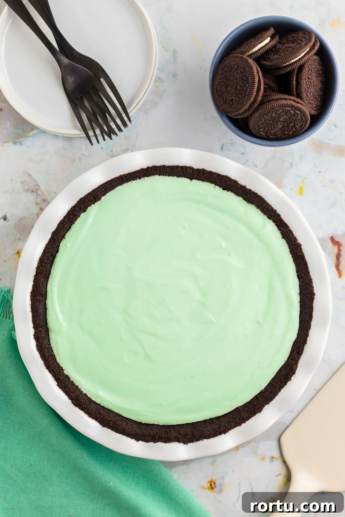 Creamy Mint Grasshopper Pie Recipe That Impresses 9 Grasshopper pie in a white dish before chopped cookies were added to the top of the pie.