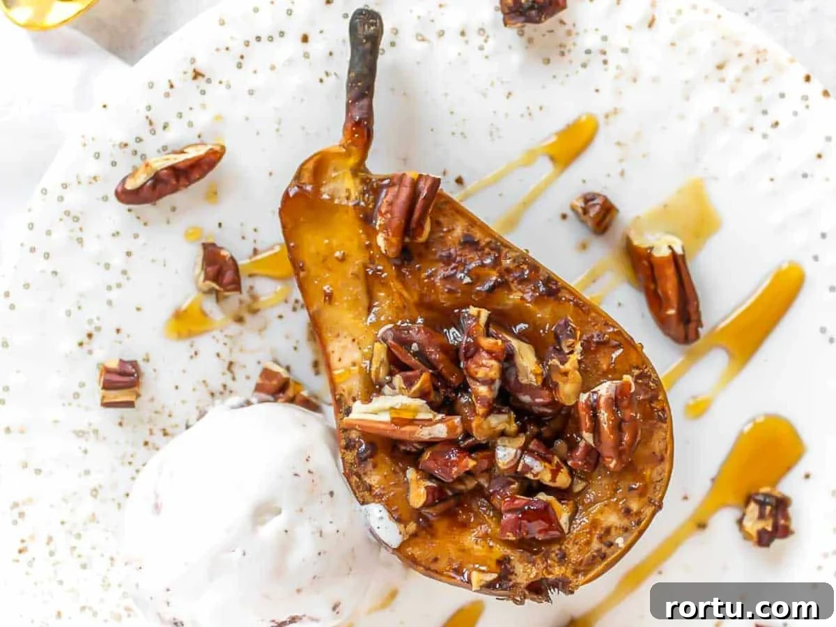 half pear on a plate with nuts and ice cream