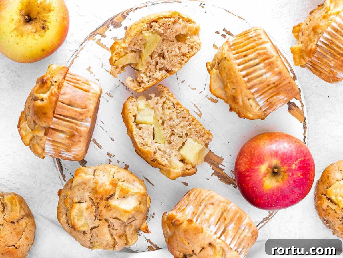 cut open apple muffin with apple chunks and grated apples
