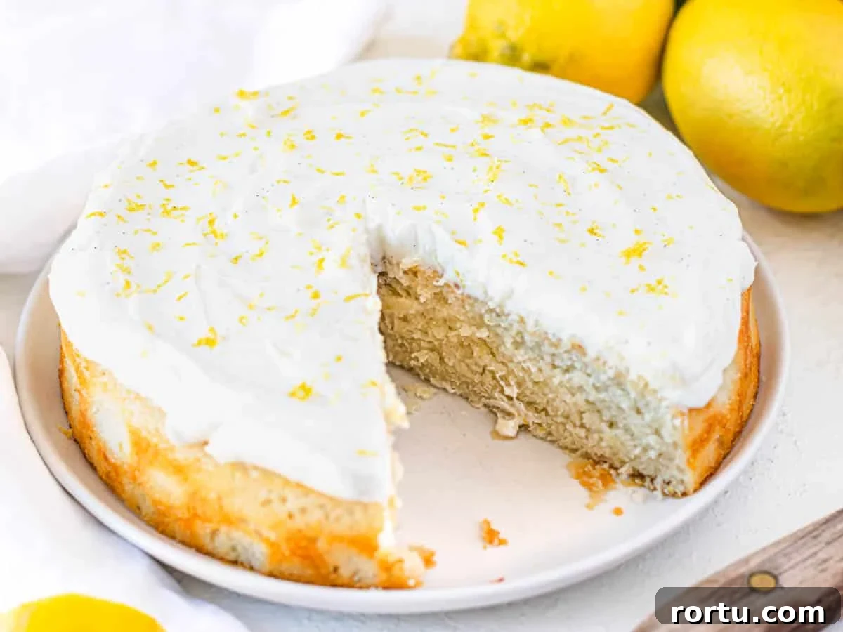 vegan lemon cake with lemon zest and a missing slice