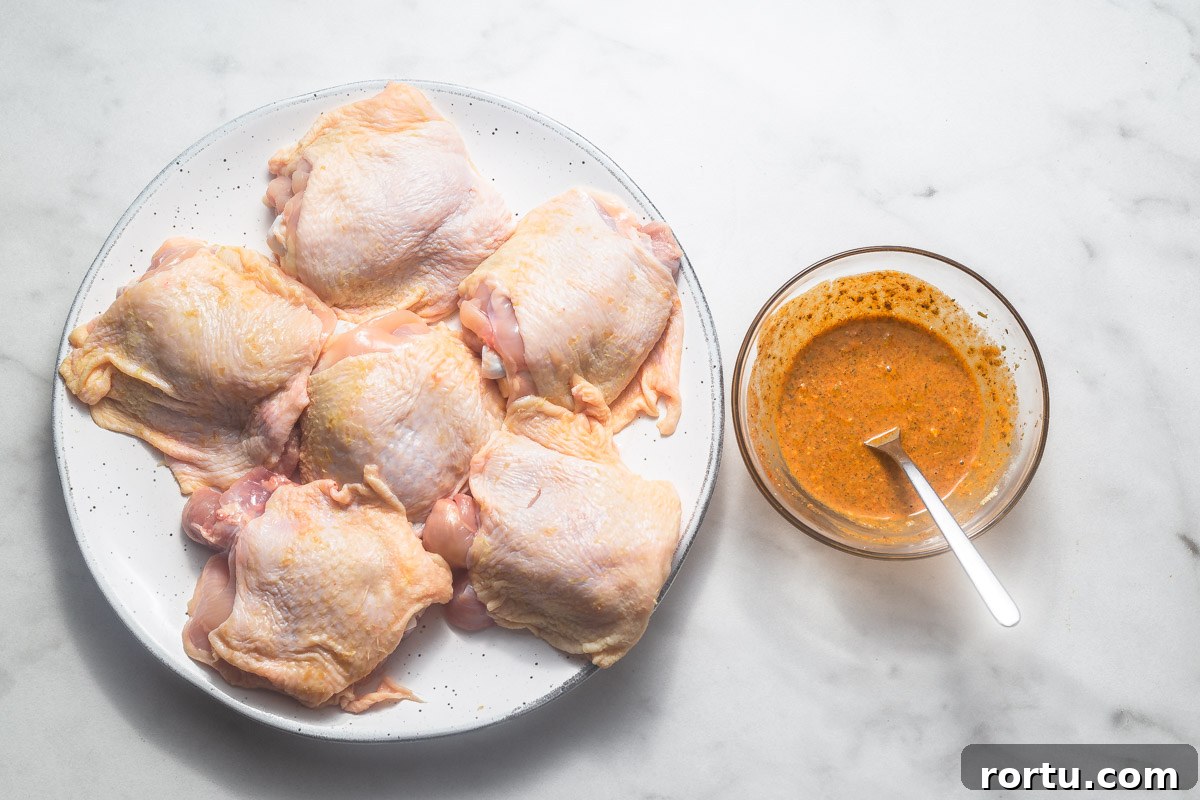 chicken thighs with seasoning ready to roast