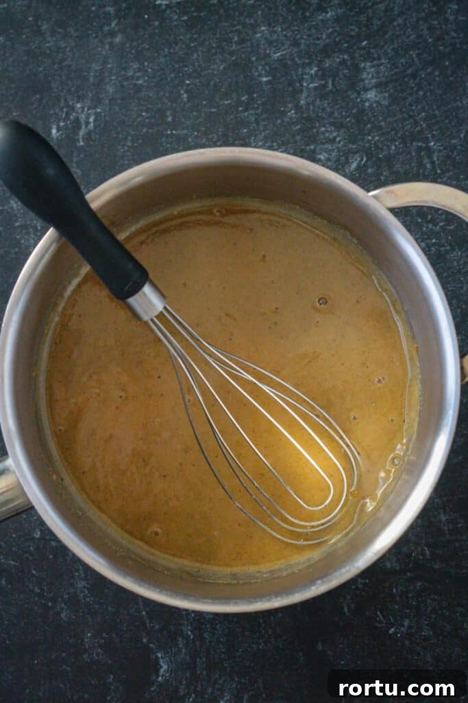 A small amount of broth mixed with the roux to create a smooth texture.