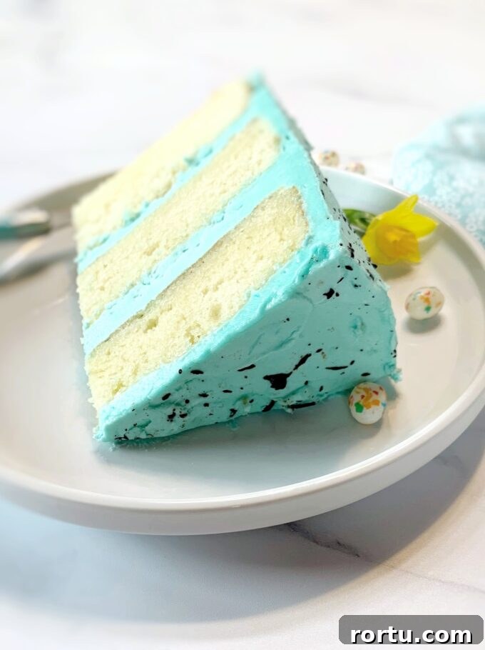 Speckled Easter Cake Recipe: Festive Marbled Holiday Cake 5 A slice of speckled Easter cake on a white plate.