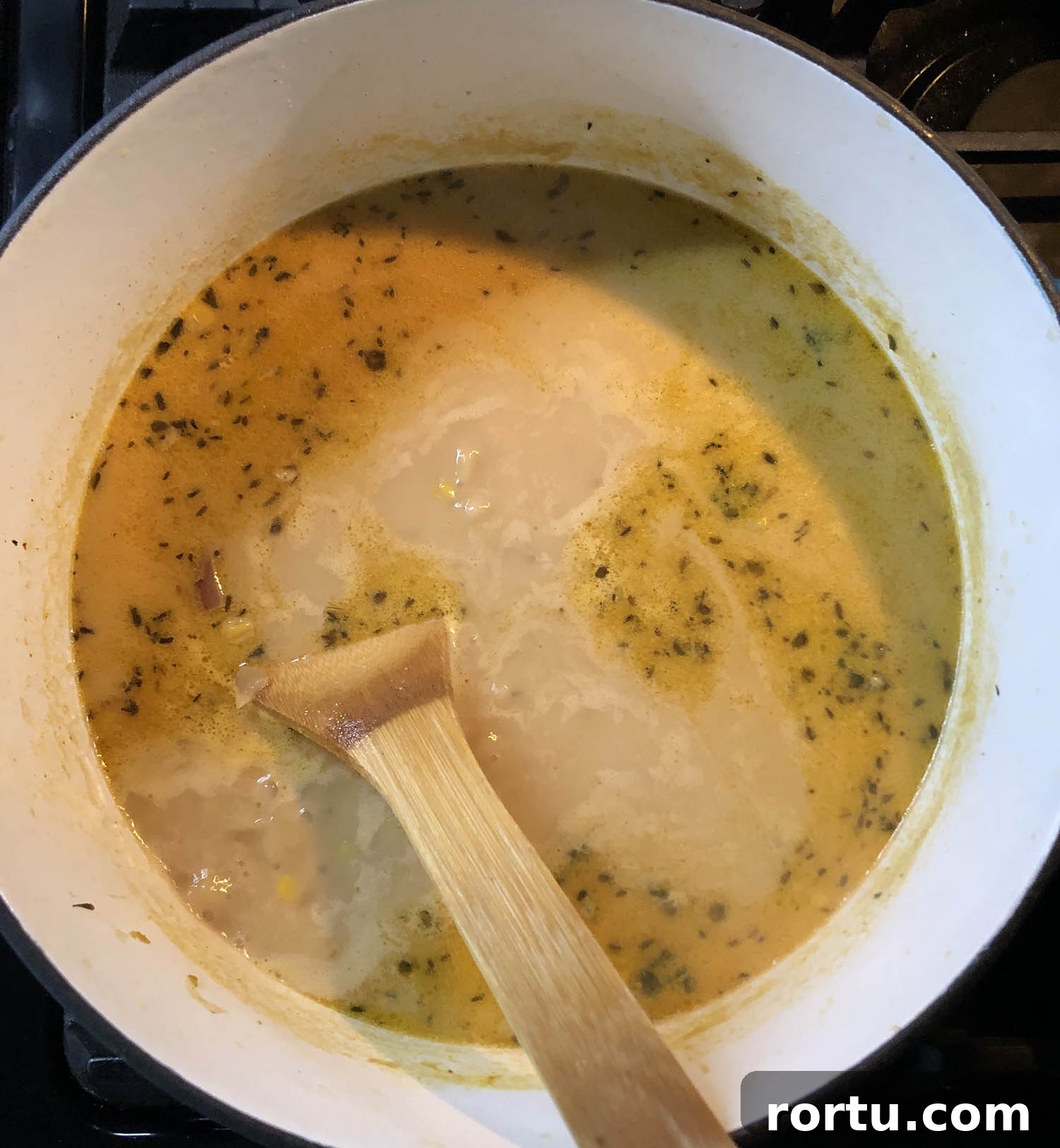 Creamy Corn Chowder Made with Frozen Corn 5 stirring cream into a corn chowder