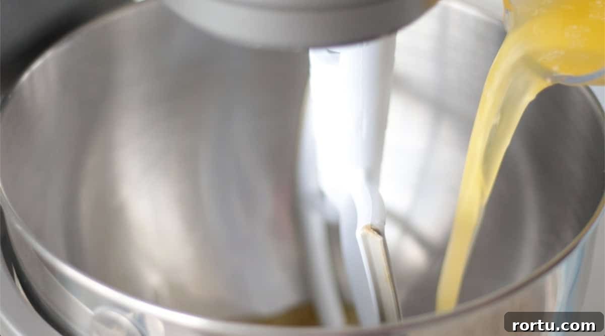 Melted butter poured into metal mixing bowl.