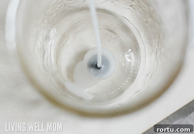 Make Homemade Citronella Candles to Repel Mosquitoes 7 placing wick in the base on the repurposed glass jar