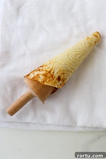 Krumkake rolled around a cone form.