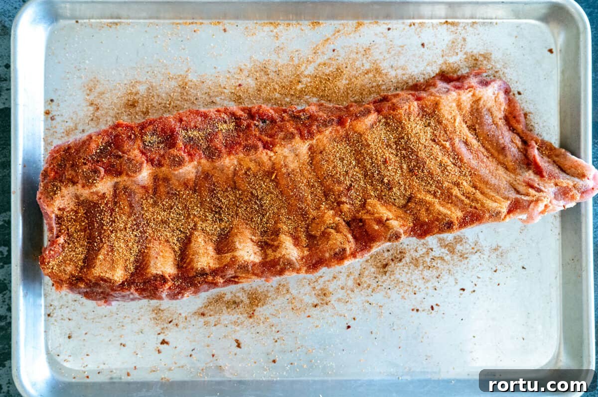 Smoked Baby Back Ribs on the Ninja FlexFlame Grill 4 back of ribs seasoned.
