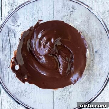 Melted dark chocolate in a bowl viewed from above.