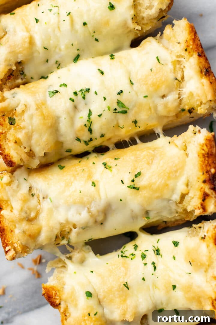 Indulgent Garlic Cheese Bread Recipe for Garlic Lovers 2 closeup of four slices of cheesy garlic bread