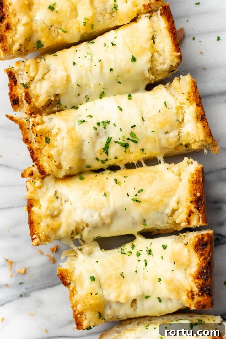 Indulgent Garlic Cheese Bread Recipe for Garlic Lovers 7 several slices of garlic bread on a marble surface