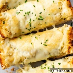 Indulgent Garlic Cheese Bread Recipe for Garlic Lovers 8 closeup of four slices of cheesy garlic bread