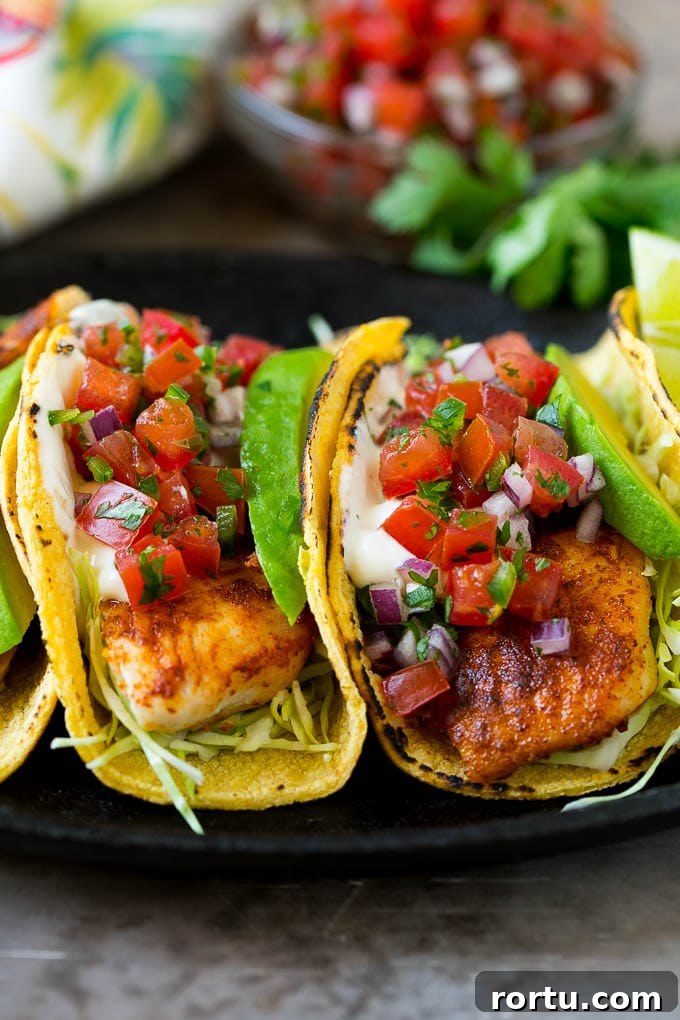 Assembled fish tacos Fish tacos with cabbage, avocado, salsa and creamy sauce.