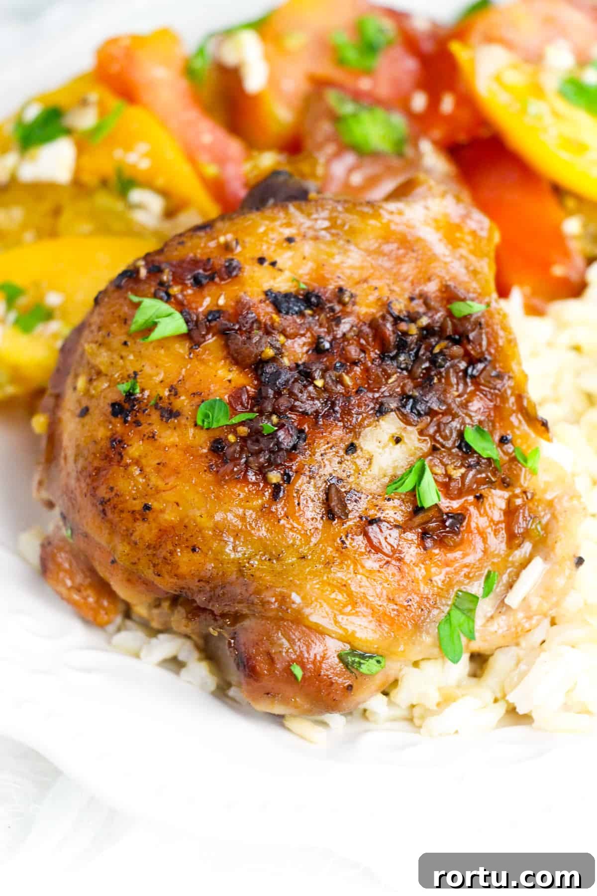 Crockpot brown sugar garlic chicken thigh served over rice with tomato salad 