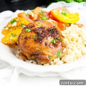 Brown sugar garlic chicken thigh made in the crockpot served over rice with tomato salad