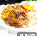 Brown sugar garlic chicken thigh made in the crockpot served over rice with tomato salad