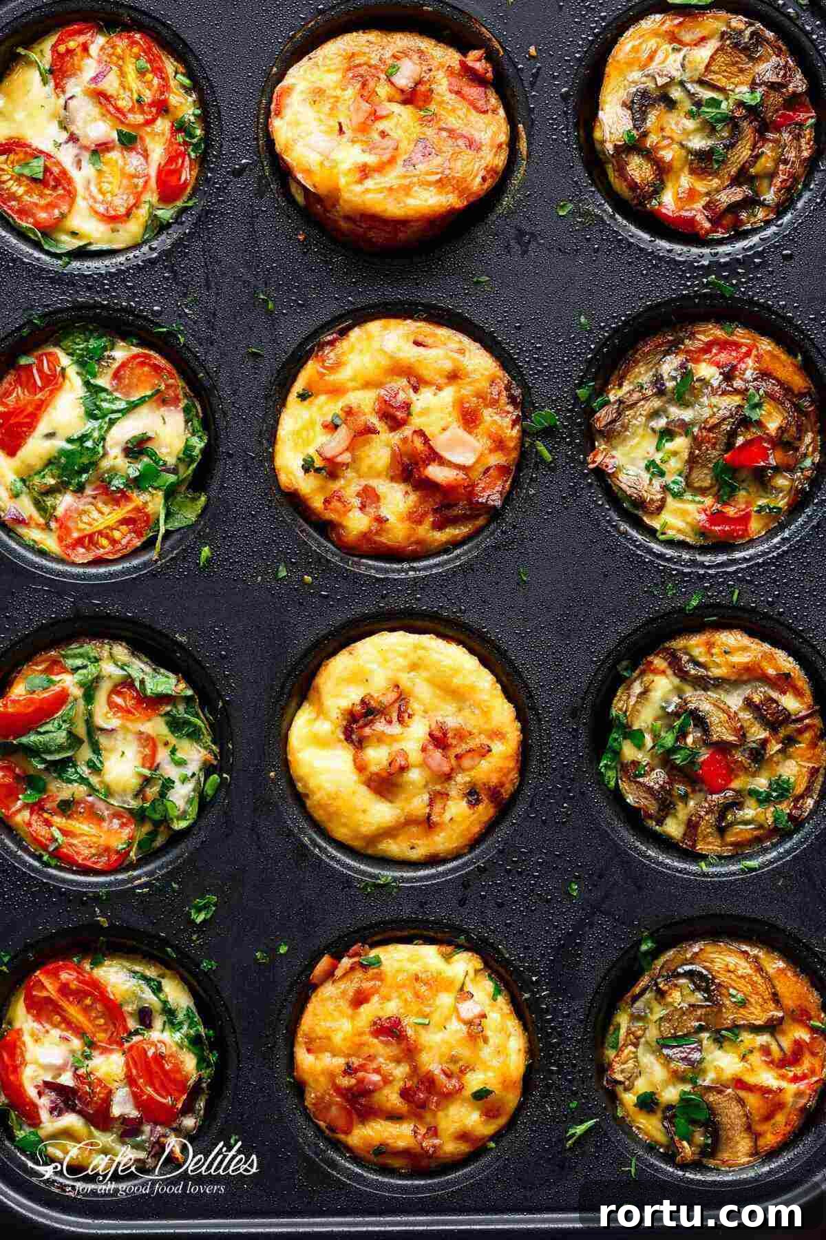 A muffin tray showcasing three rows of breakfast muffins: one row with spinach, tomato, and cheese; another with egg and cheese muffins topped with bacon; and the third with tomatoes, mushrooms, and green herbs.