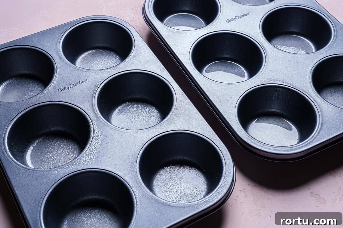 Image of muffin tins ready to be filled with egg mixture.