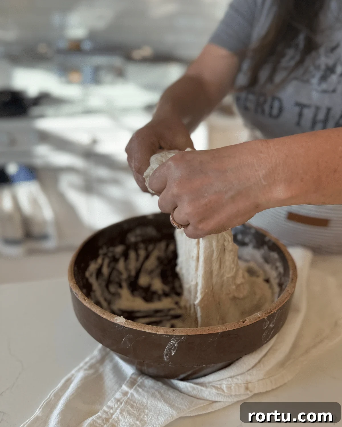 stretching sourdough bread dough on another side