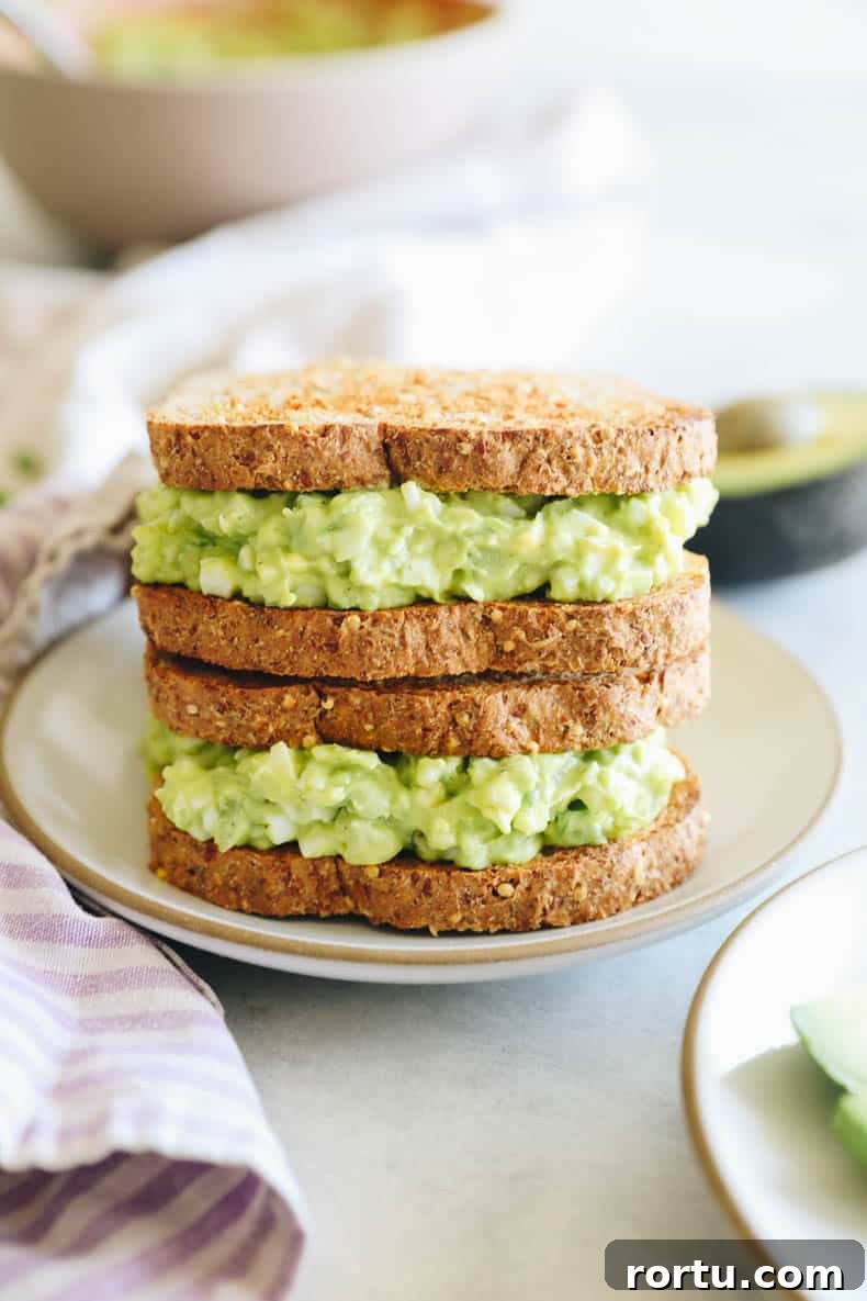 Creamy Avocado Egg Salad Recipe for Quick Lunch or Brunch 2 avocado egg salad on a sandwich.