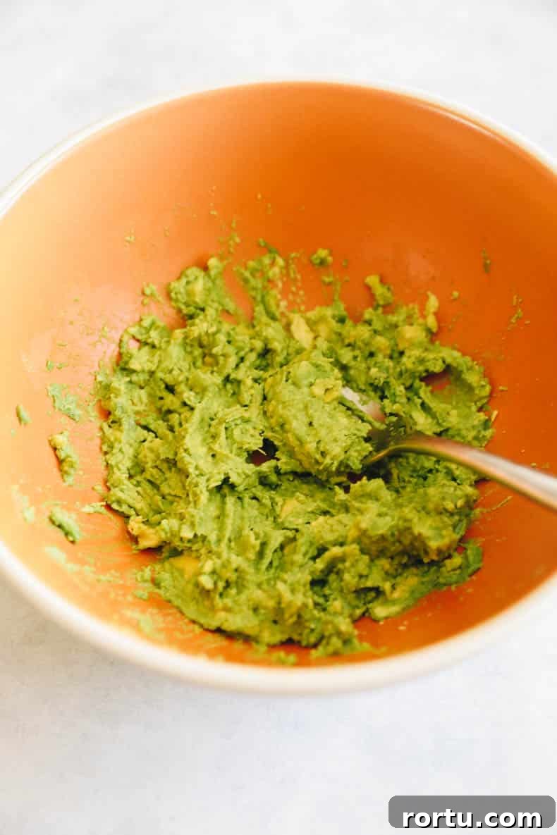 Creamy Avocado Egg Salad Recipe for Quick Lunch or Brunch 4 mashed avocado in a bowl