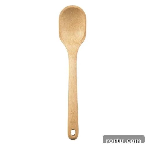 A wooden spoon with a rounded bowl and long handle.