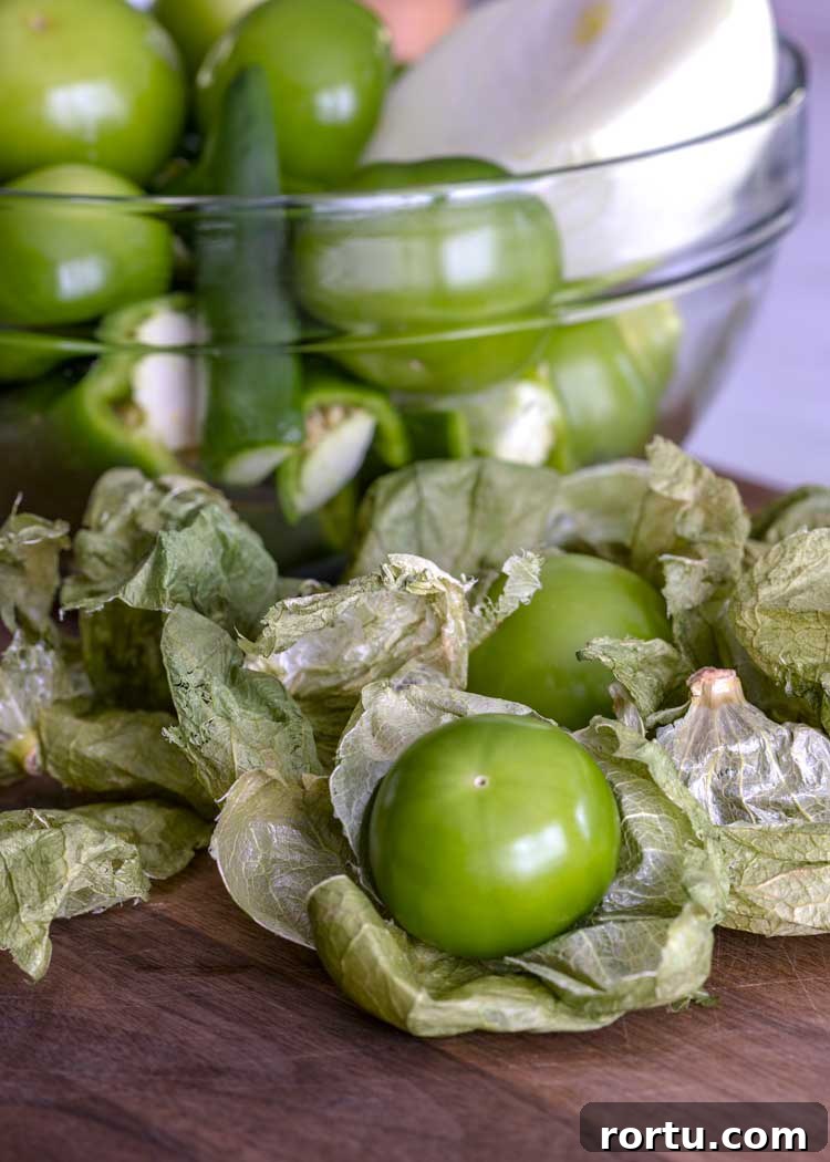 tomatillos and chiles in a glass bowl