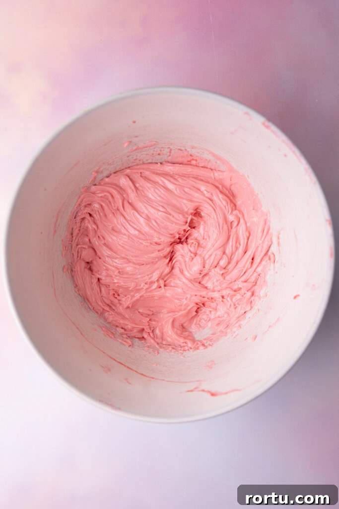 Softened butter and raspberry juice creamed together in a large bowl.