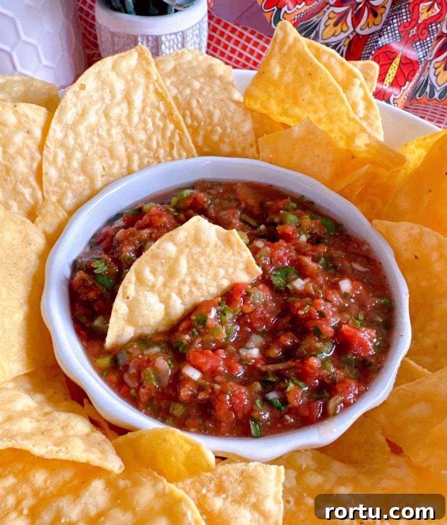 Salsa and chips on a plate.