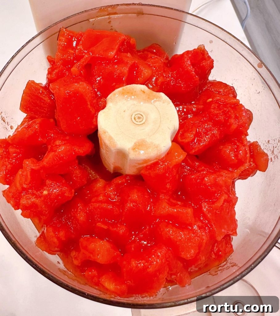 Processing tomatoes in the food processor.