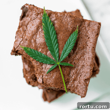 A picture of a stack of cannabis brownies with a cannabis leaf.