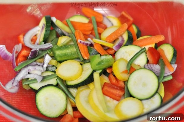 Cut veggies are placed in large bowl to mix with seasonings.