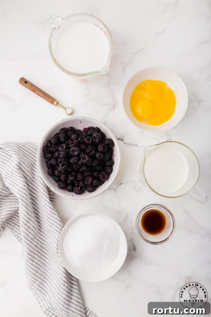Ingredients for black raspberry ice cream, each in separate bowls on a marble counter