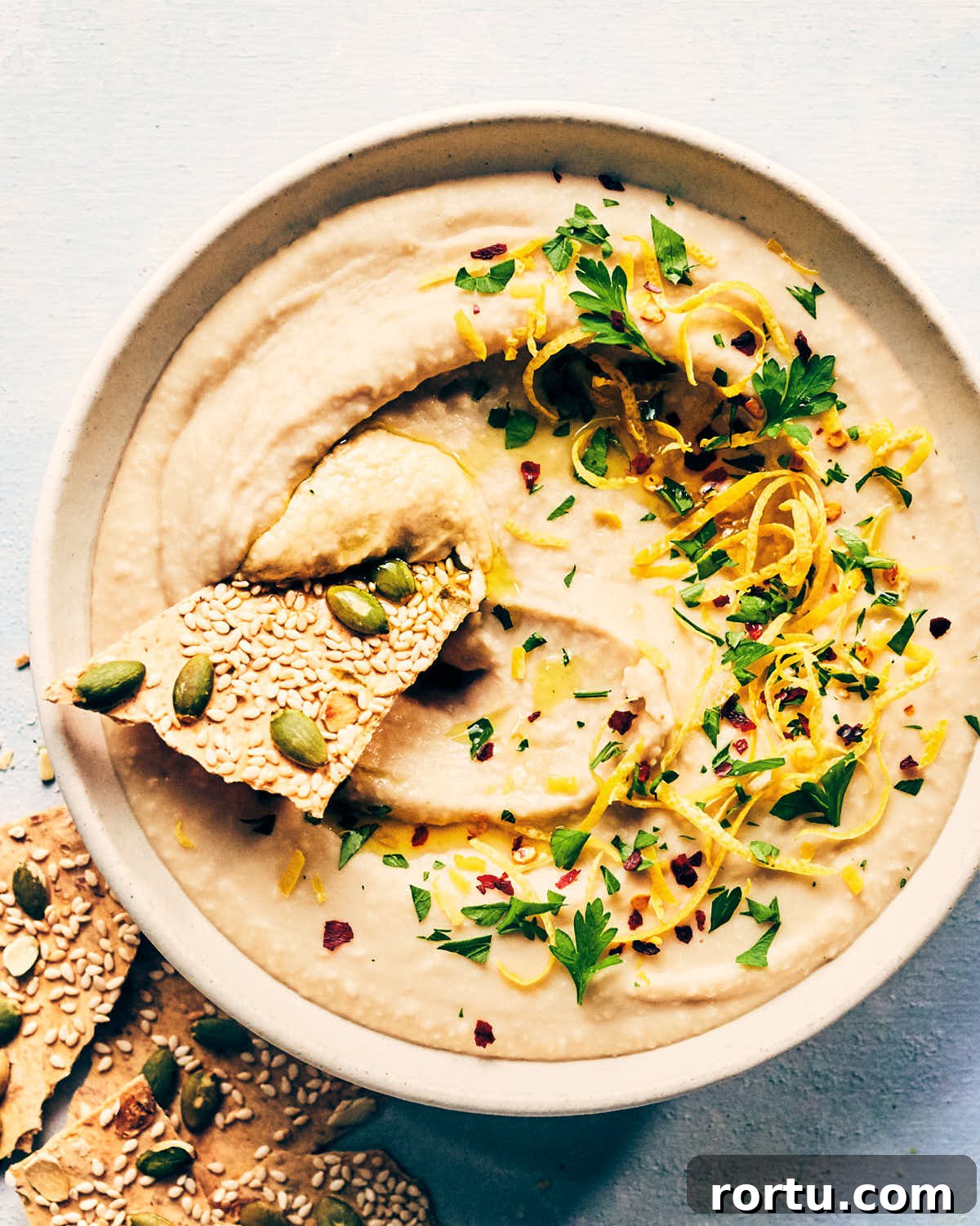 Dipping chip into white bean dip