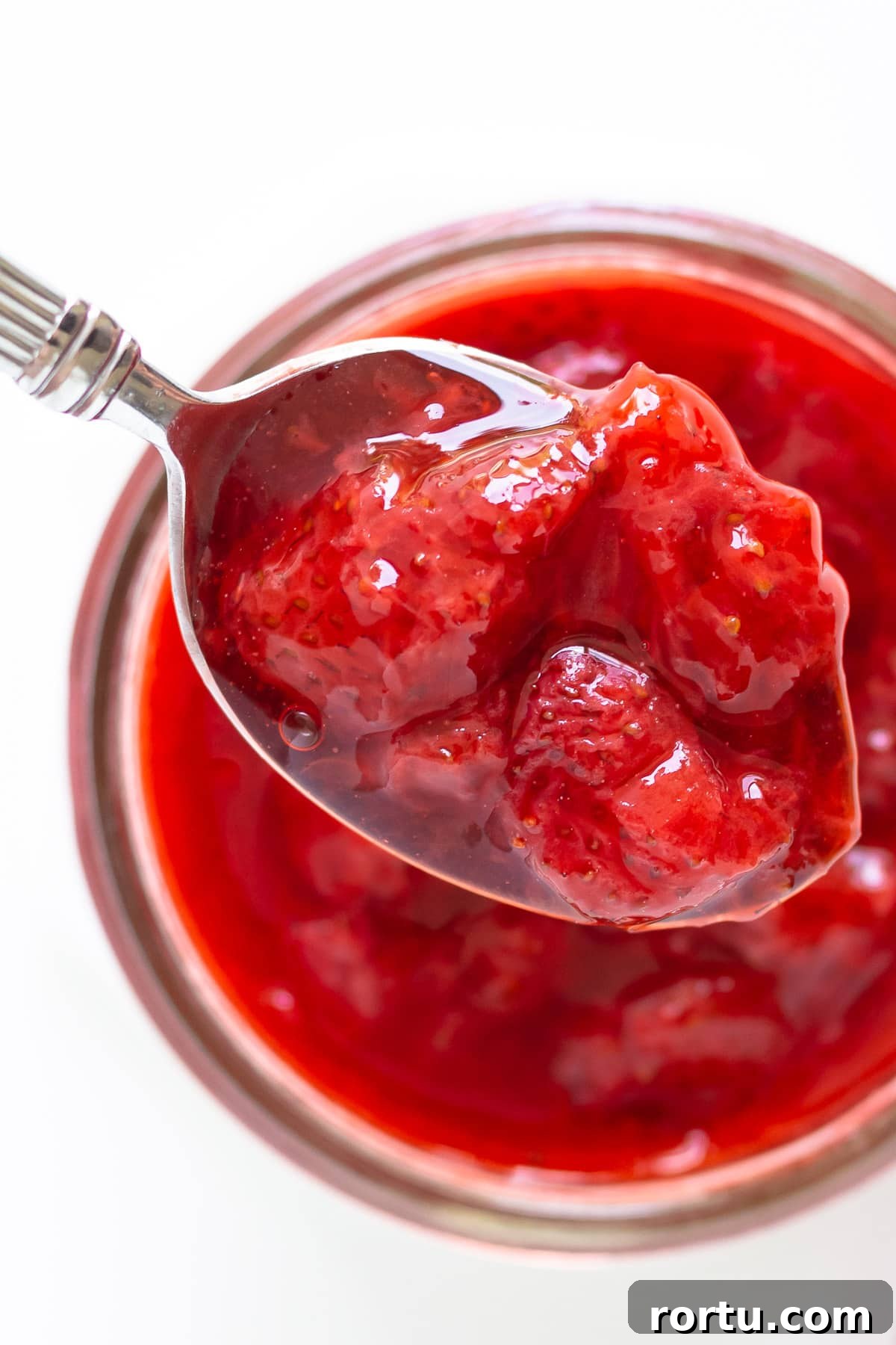 Overhead of spoonful of homemade strawberry topping.