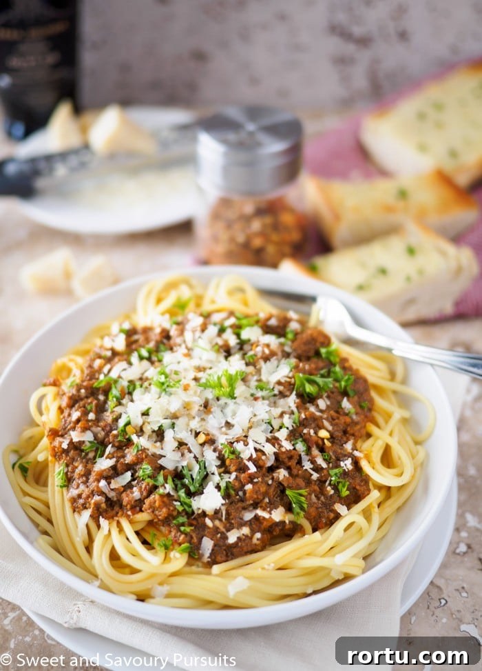 Bowl of spaghetti topped with meat sauce.
