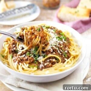 Bowl of spaghetti topped with meat sauce.