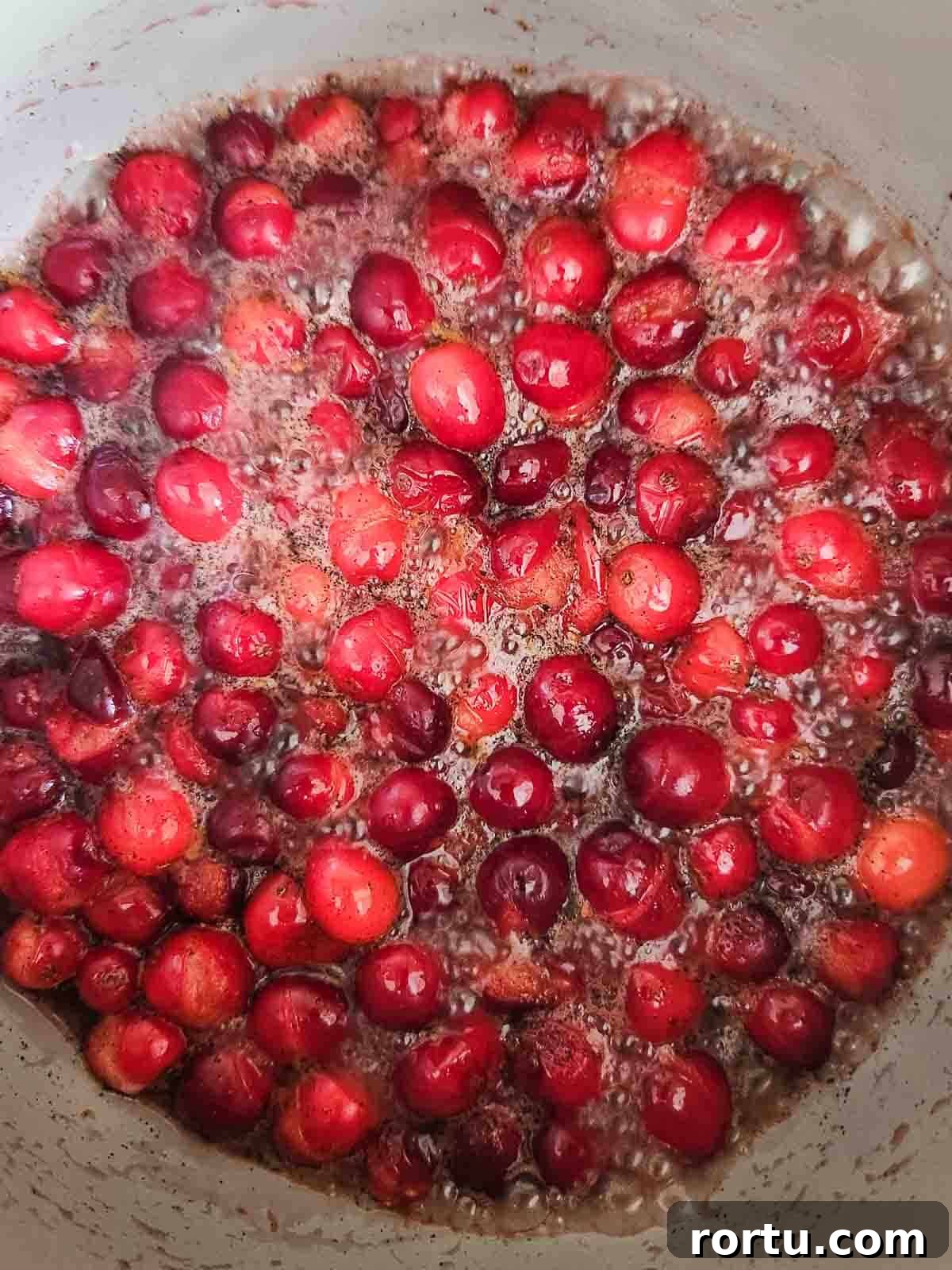 Boiled cranberries in a pot.