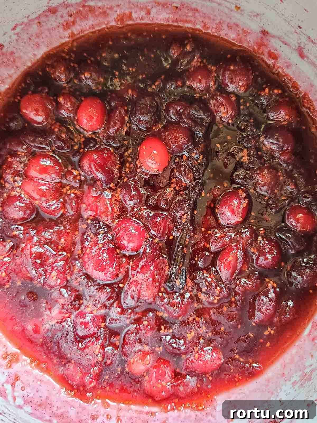 Overhead of cranberry compote in a pot.