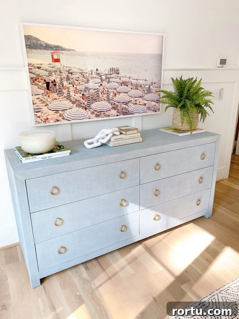 a shot of a frame TV in a bedroom over the driftway dresser