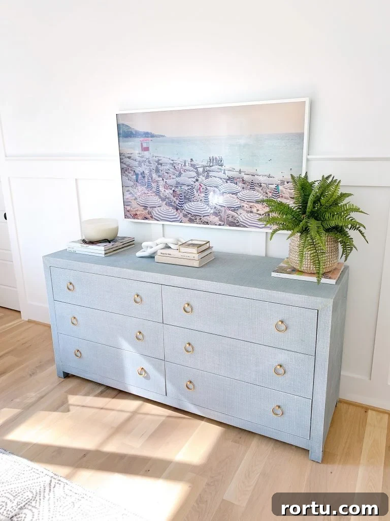 a Samsung Frame tv above a dresser