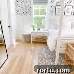 a black and white bedroom with black and white wallpaper