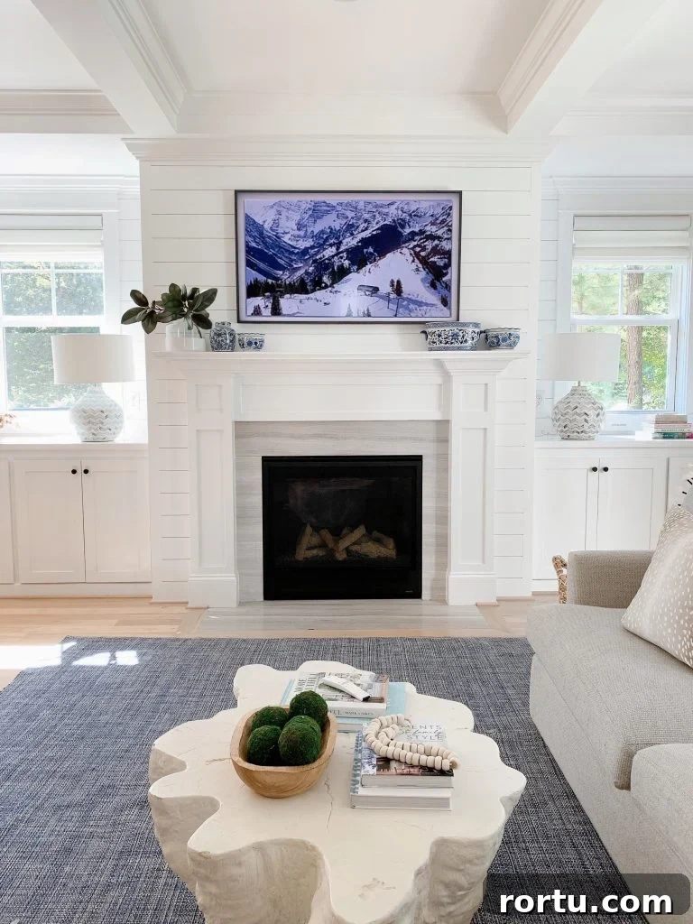 Samsung Frame tv above a fireplace mantel in a living room